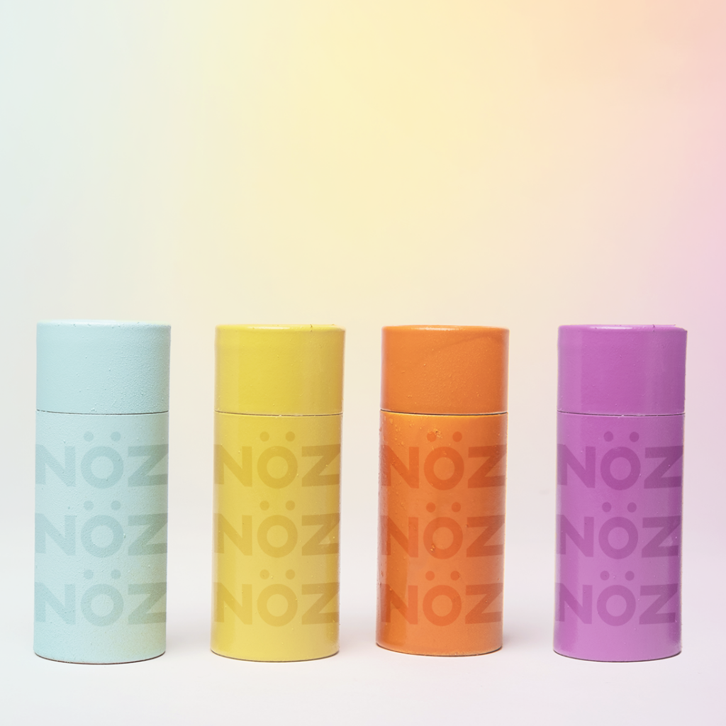Nöz Vegan Chemical Sunscreen Sticks in Blue. Yellow, Orange, and Purple 